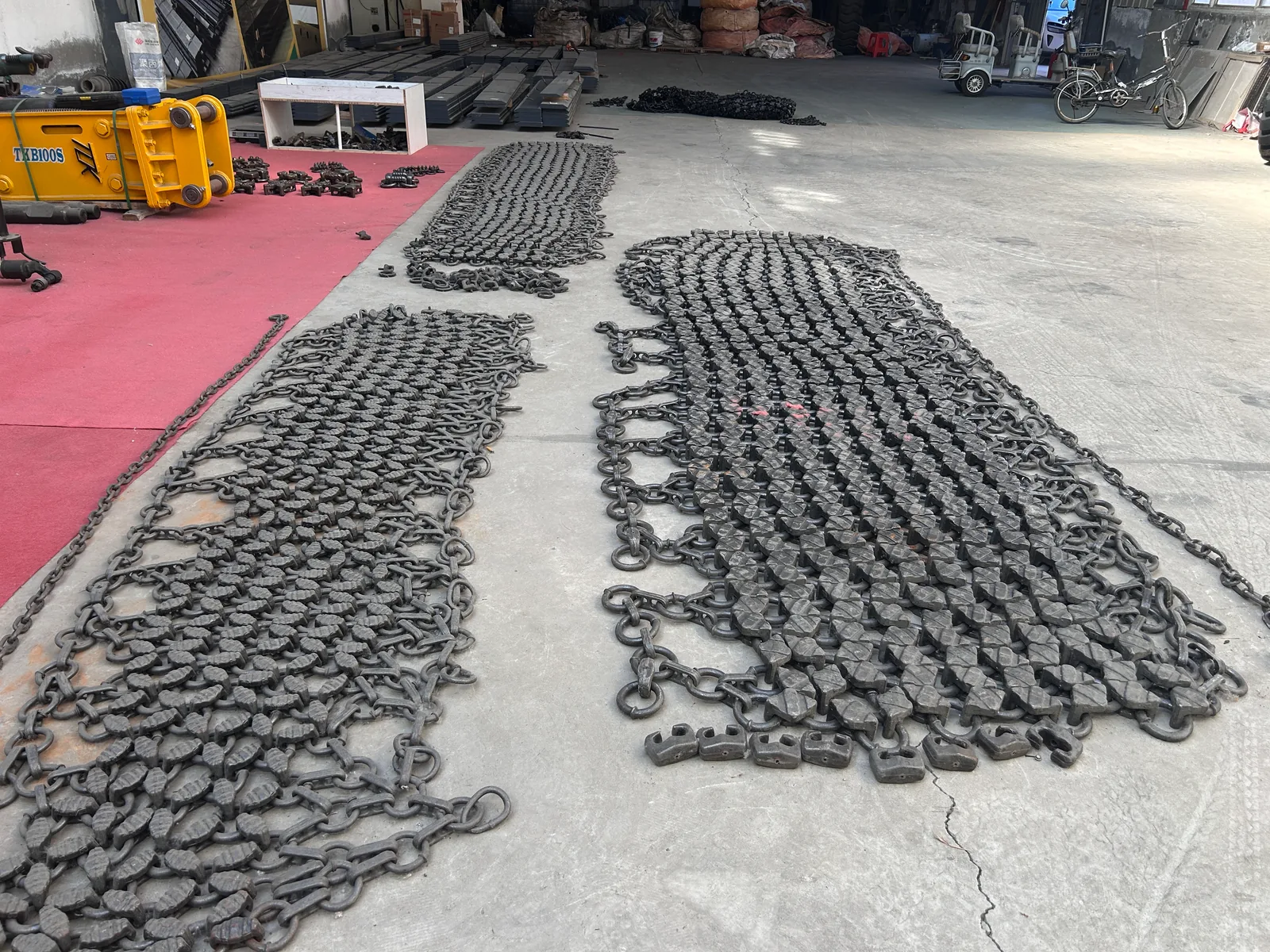 Two lengths of tyre protection chain mesh laid out for inspection