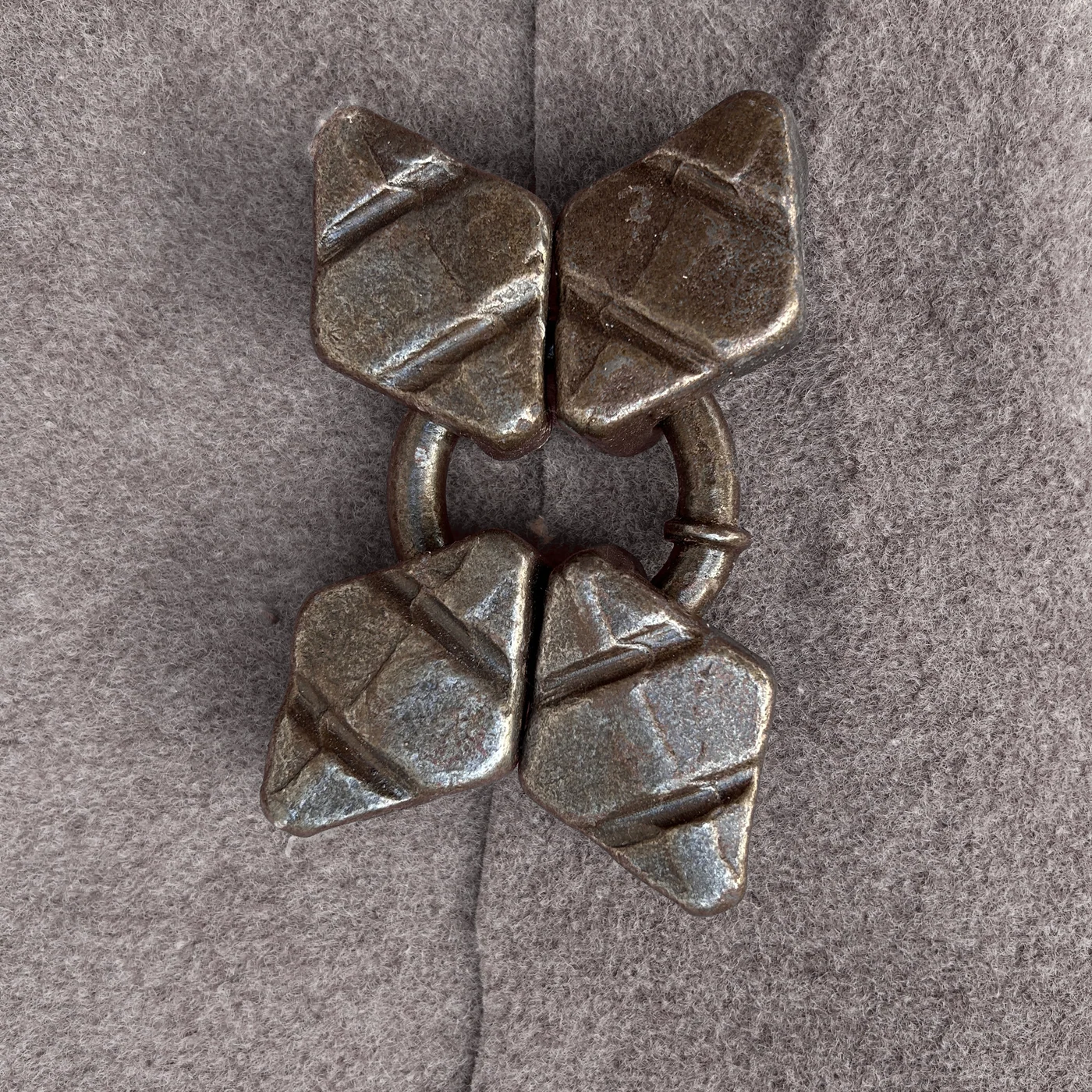 Four broad angled metal wear elements connected around a ring