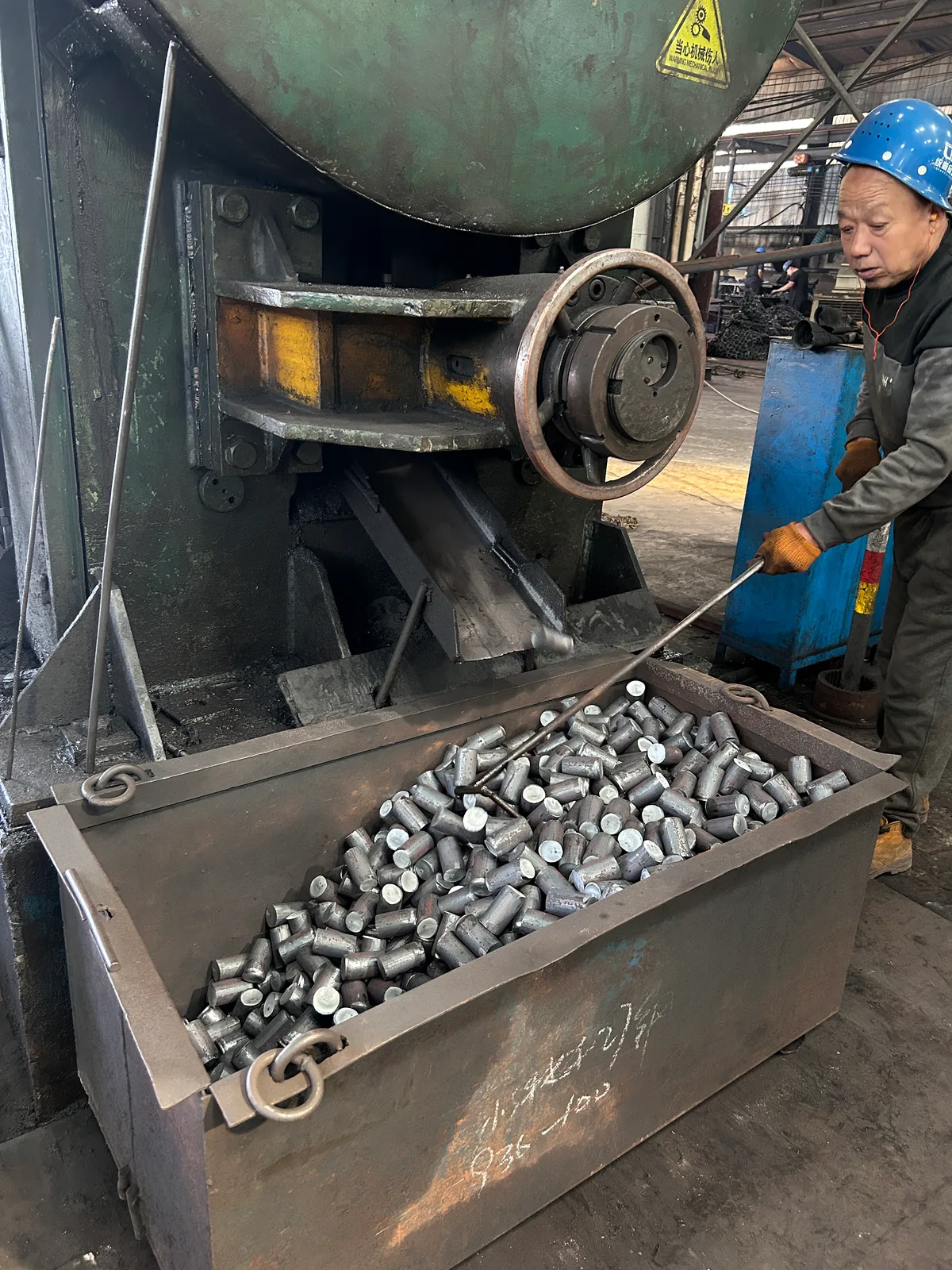 Metal blanks beside equipment in a production workshop