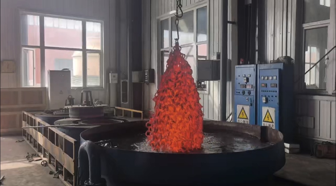 Glowing chain suspended above a treatment tank in a workshop